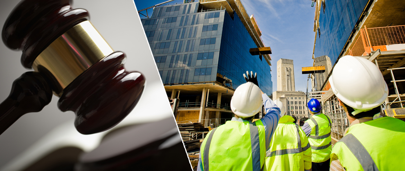 Construction workers in safety vests and helmets gesturing towards a building under construction.