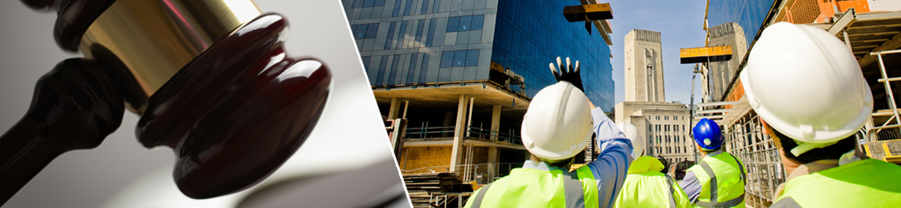 Construction workers in safety vests and helmets gesturing towards a building under construction.